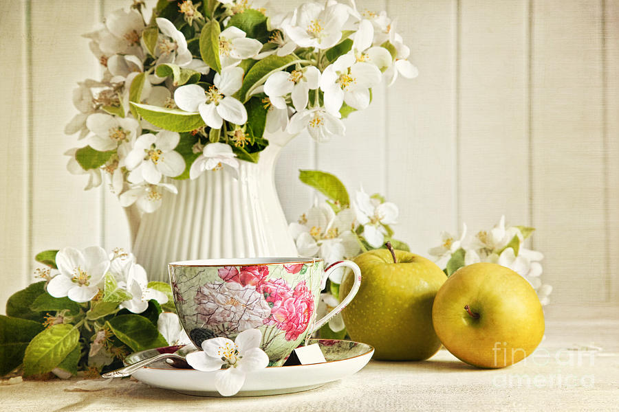Tea cup with flower blossoms and green apples Photograph by Sandra Cunningham