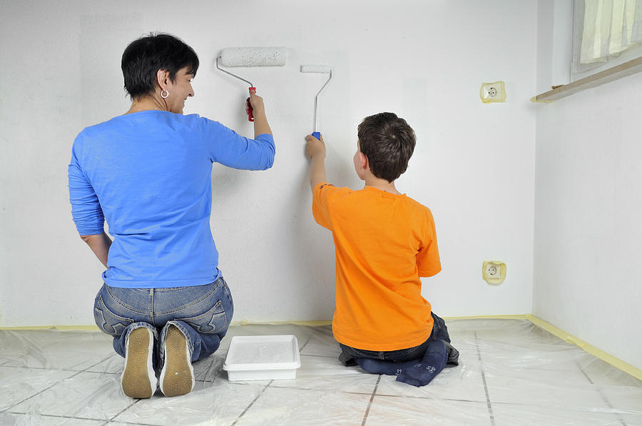 Teamwork - Mother and child painting wall Photograph by Matthias Hauser