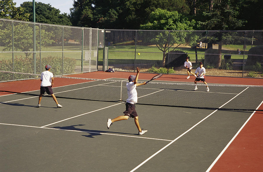 Teenagers Play Doubles Tennis Photograph by James A. Sugar