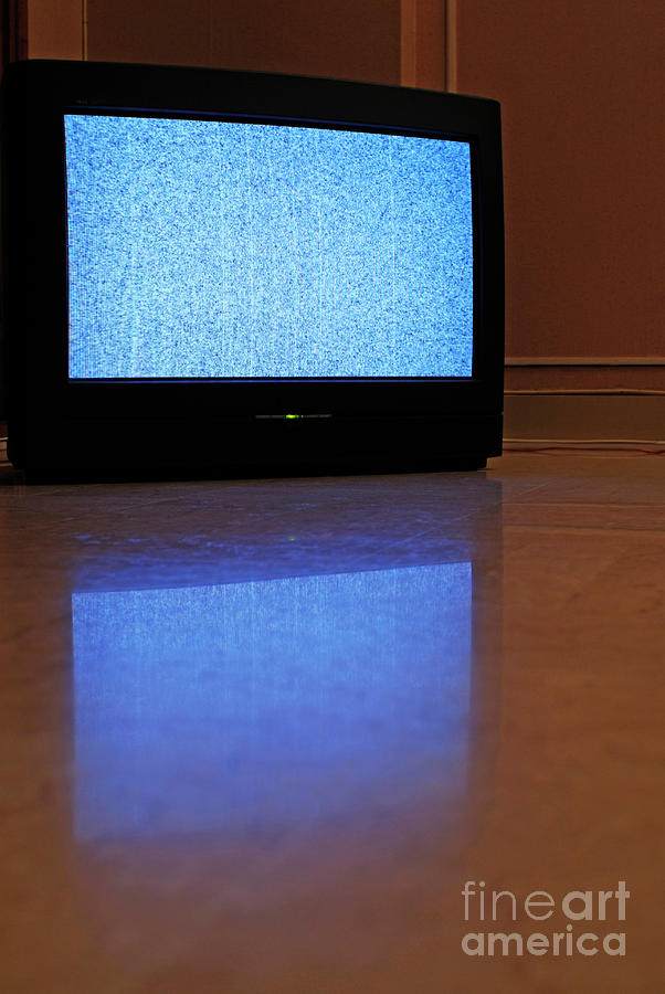 Television displaying static reflected on floor Photograph by Sami