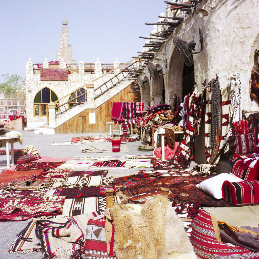 Textiles in Qatari souq Photograph by Paul Cowan