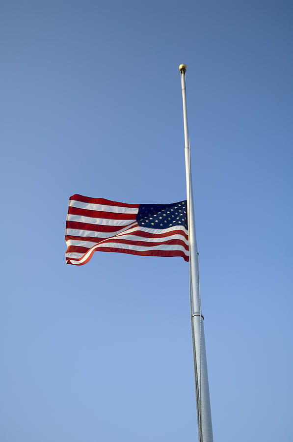 The American Flag At Half Staff Due Photograph by Joel Sartore