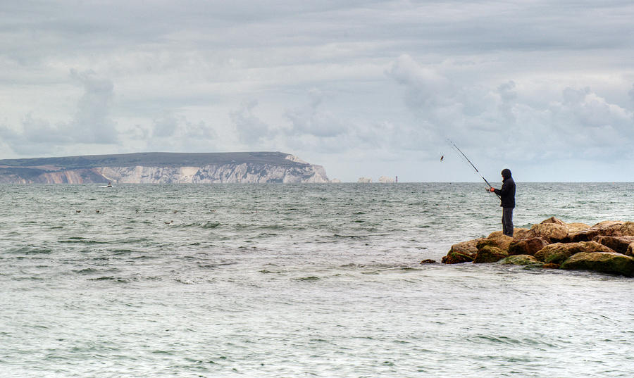 The lone angler Photograph by Chris Day