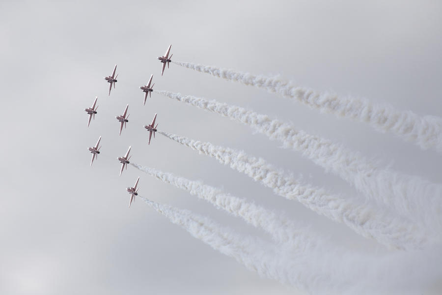 The Red Arrows glistening in the sunlight Photograph by Ian Middleton