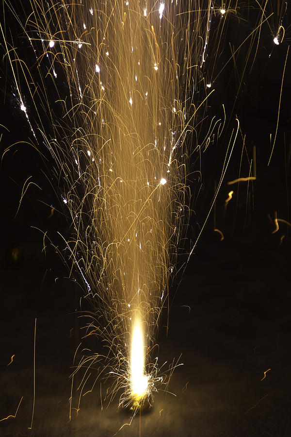 The sparks put out by a firecracker during Diwali celebrations Photograph by Ashish Agarwal