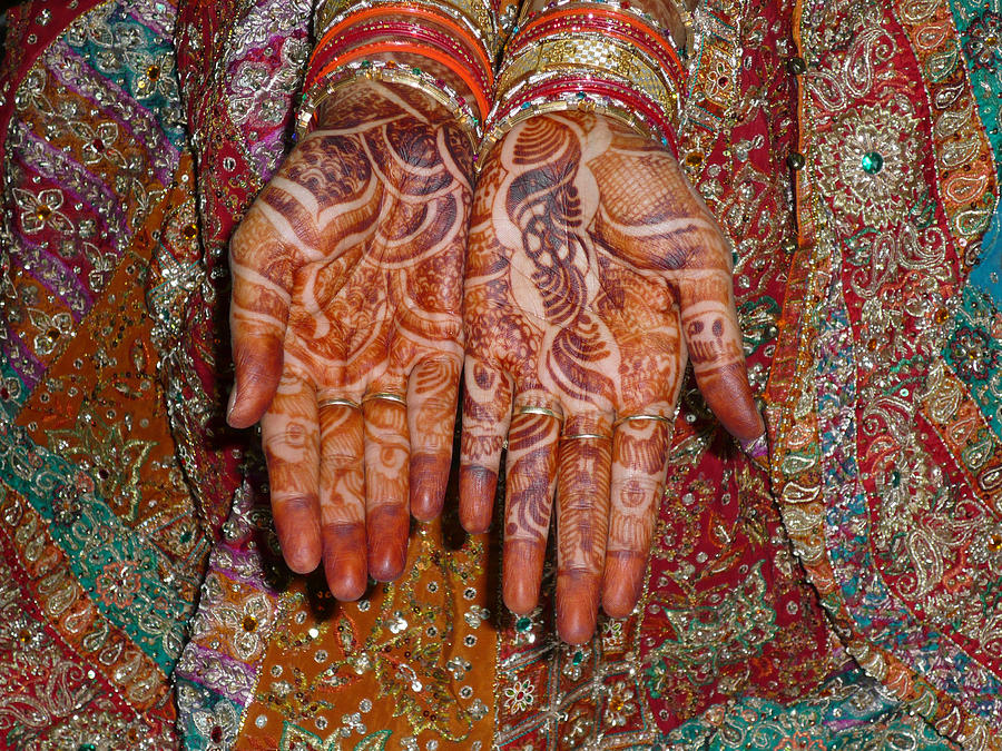 The wonderfully decorated hands and clothes of an Indian bride Photograph by Ashish Agarwal