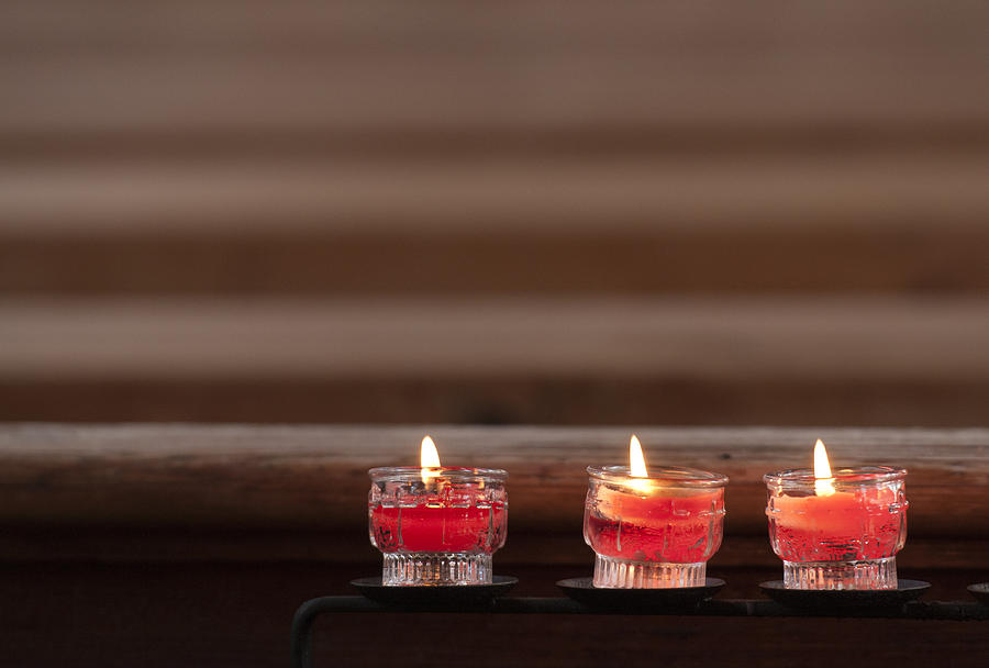 Three candles burning in a church Photograph by Matthias Hauser