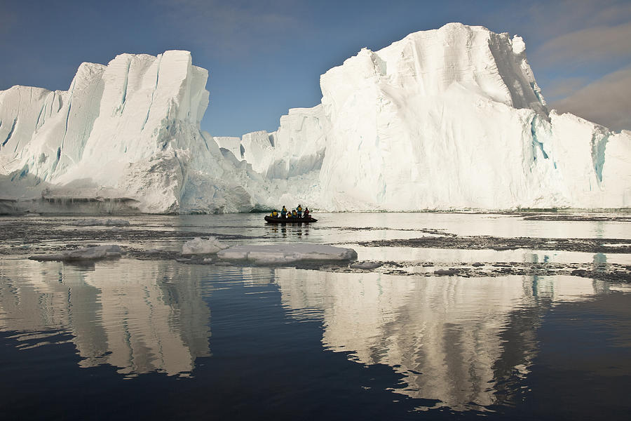 Tourists In Zodiac Looking At Iceberg Photograph by Colin Monteath