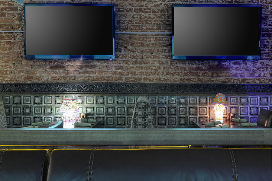 Tvs On Brick Wall In Restaurant Photograph by Magomed Magomedagaev