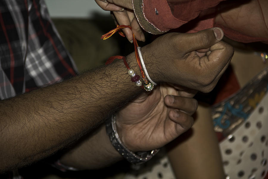 Tying rakhi on the hands of the brother Photograph by Ashish Agarwal