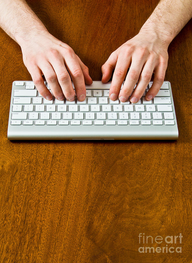 Typing On A Wireless Keyboard Photograph by Photo Researchers