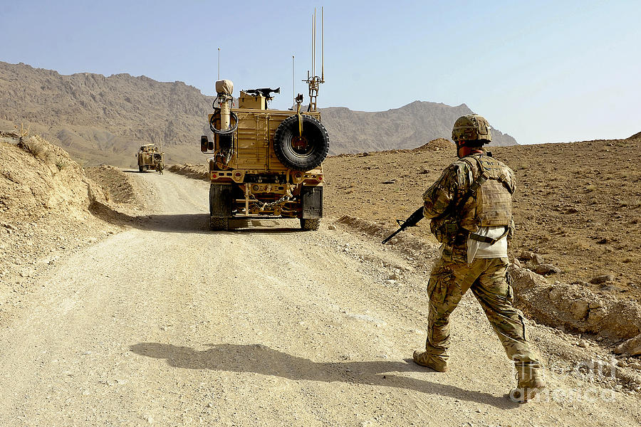 Transportation Photograph - U.s. Army Soldier Moves To His Mrap by Stocktrek Images