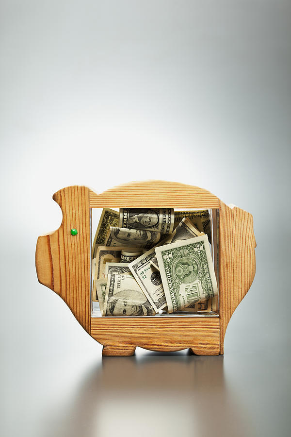 Us Dollar Banknotes In Piggy Bank Photograph by Yuji Sakai Us Dollar Banknotes In Piggy Bank Photograph by Yuji Sakai