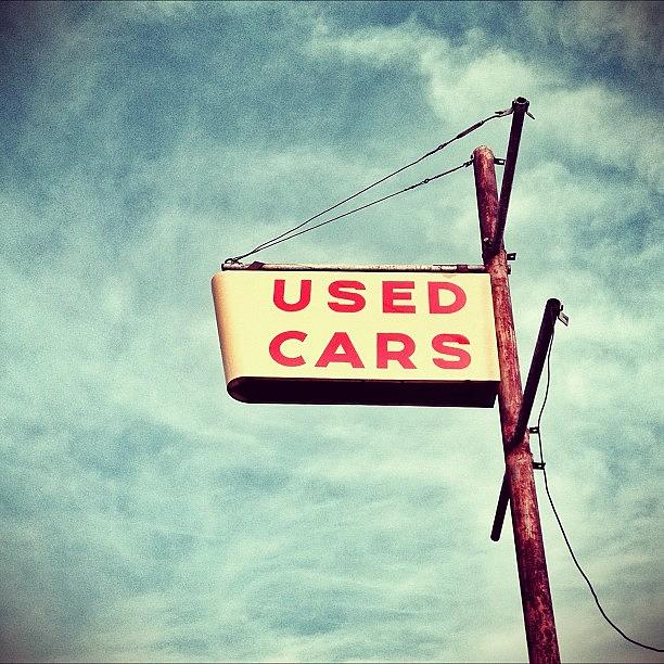 Vintage Photograph - Used Cars!  #vintage #sign #sky #clouds by Caleb Kennedy