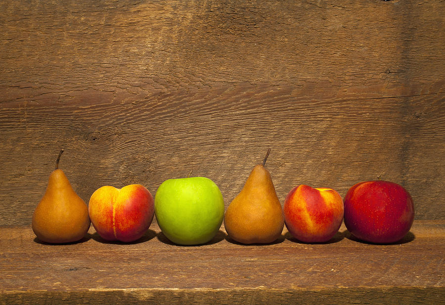 Variety Of Fruit In A Row On A Wooden Photograph by David Chapman