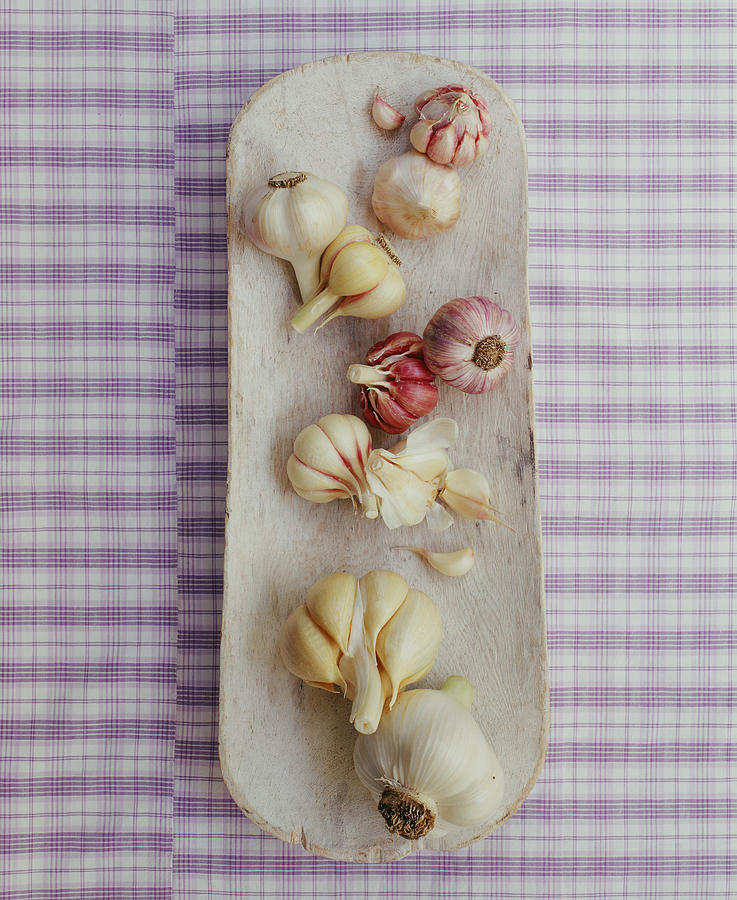 Various Garlic Cloves On A Wooden Platter Photograph by Victoria Pearson