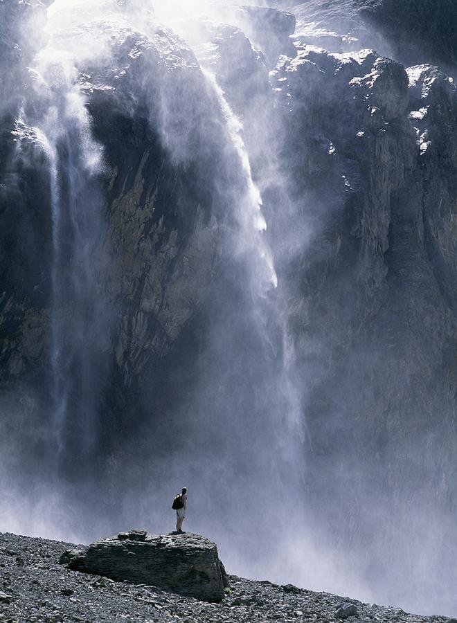 Mountain Photograph - Walker Beneath Waterfall In The Cirque by Axiom Photographic