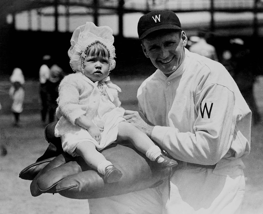 Walter Johnson holding a baby - c 1924 Photograph by International  Images