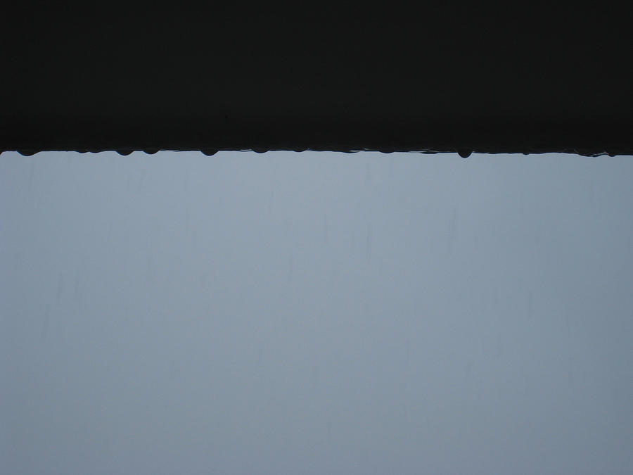 Water droplets clinging and dropping from a ledge after rain Photograph by Ashish Agarwal