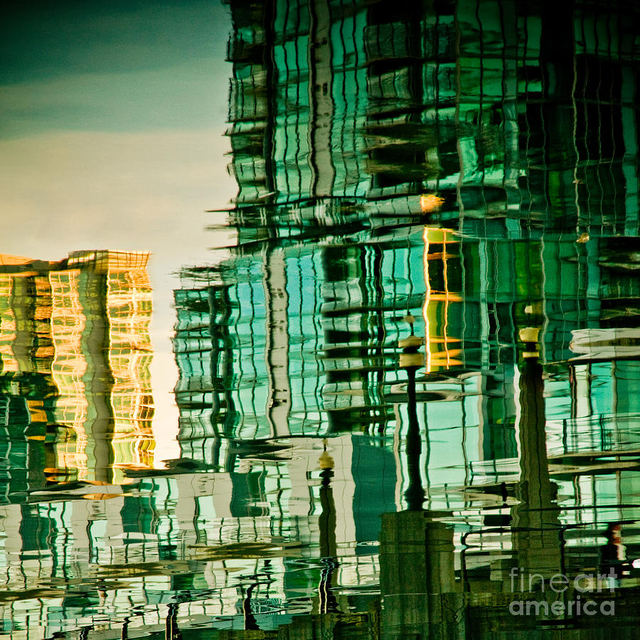 Watery skyline of city buildings. Photograph by Emilio Lovisa