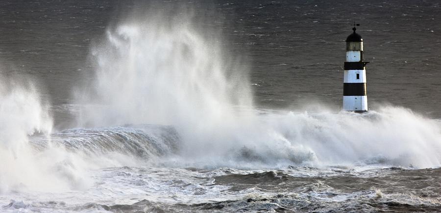 Waves Crashing On A Lighthouse Photograph by John Short