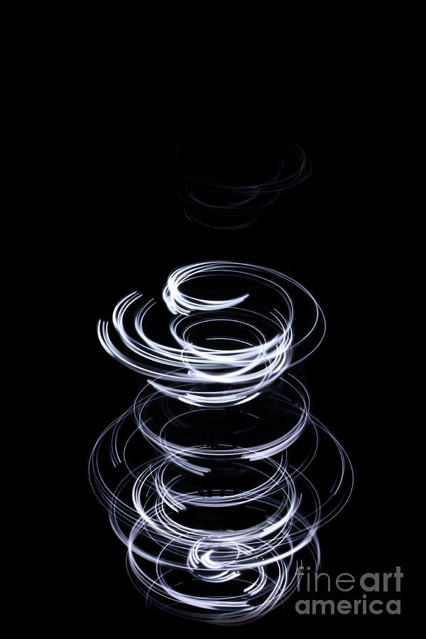 White upward swirl on black background Photograph by Simon Bratt