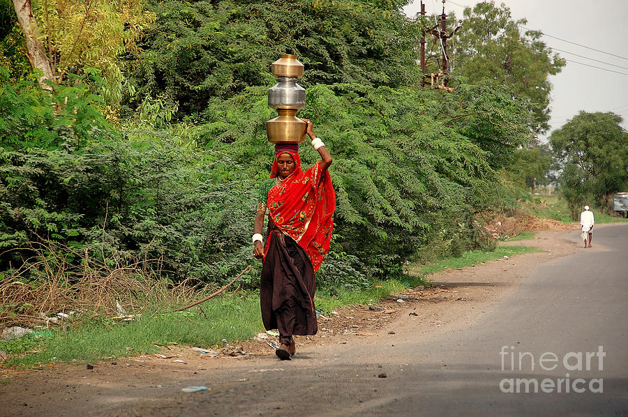 Woman Carrying Water Photograph by Charuhas Images