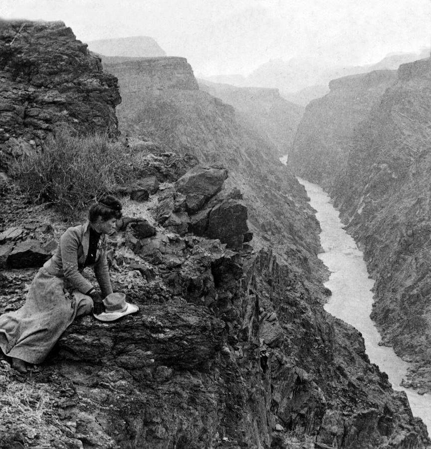 Woman looking down to the Colorado River from the Grand View Trail - Grand Canyon - c 1903 Photograph by International  Images