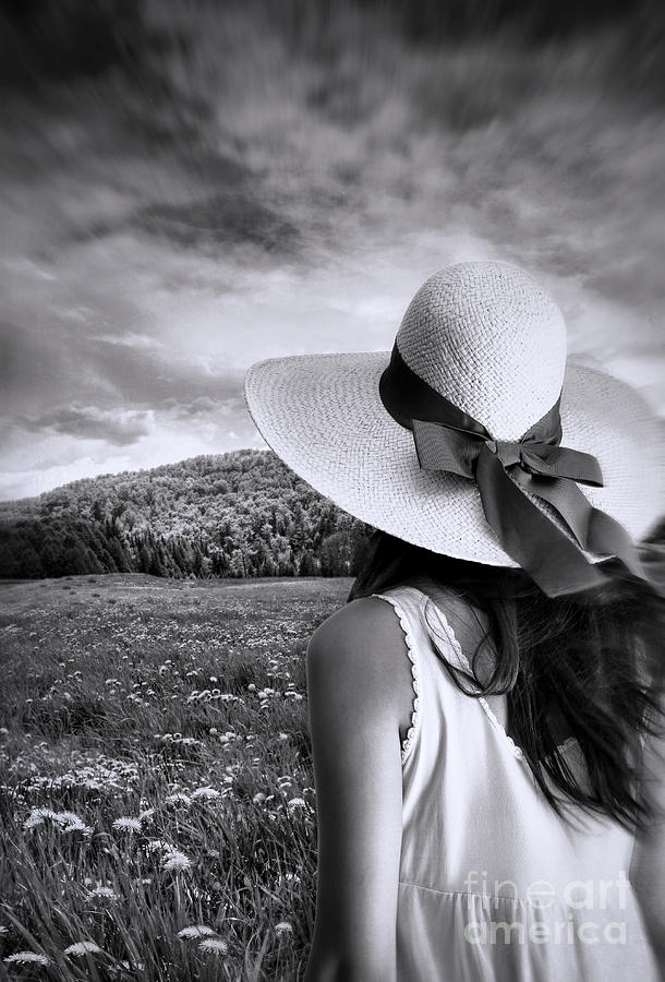 Woman staning with sun hat in a meadow of flowers Photograph by Sandra Cunningham