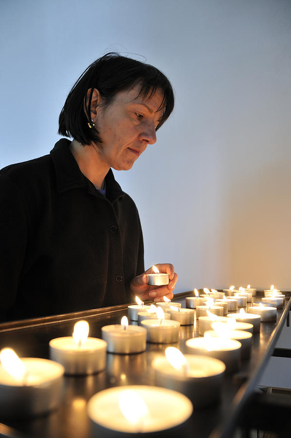 Woman with candles in church Photograph by Matthias Hauser