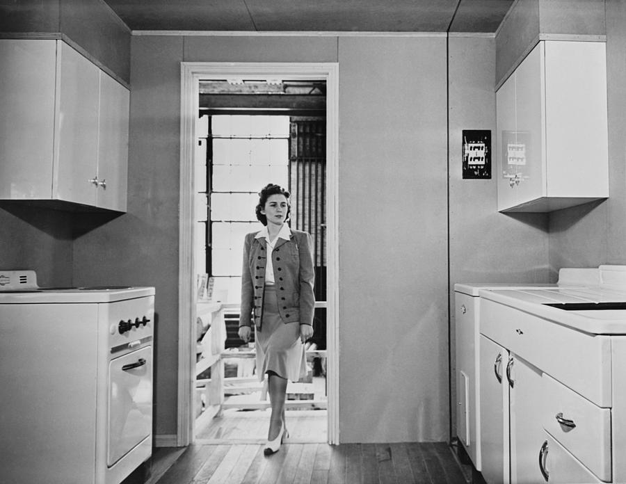 Women Enters A Modern 1940s Kitchen