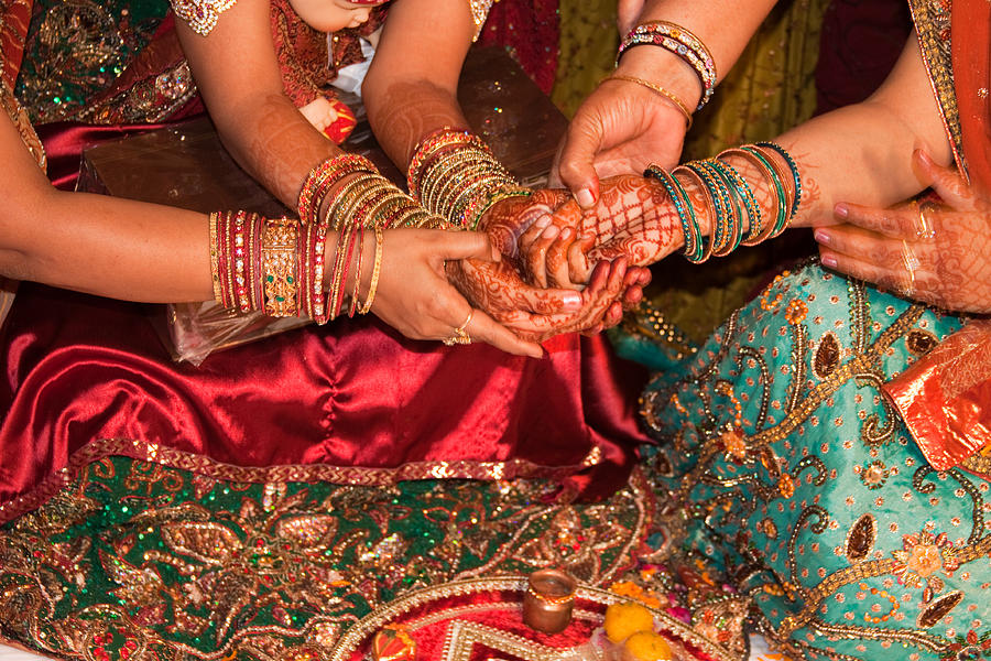 Women with decorated hands holding hands in a Hindu religious ceremony Photograph by Ashish Agarwal