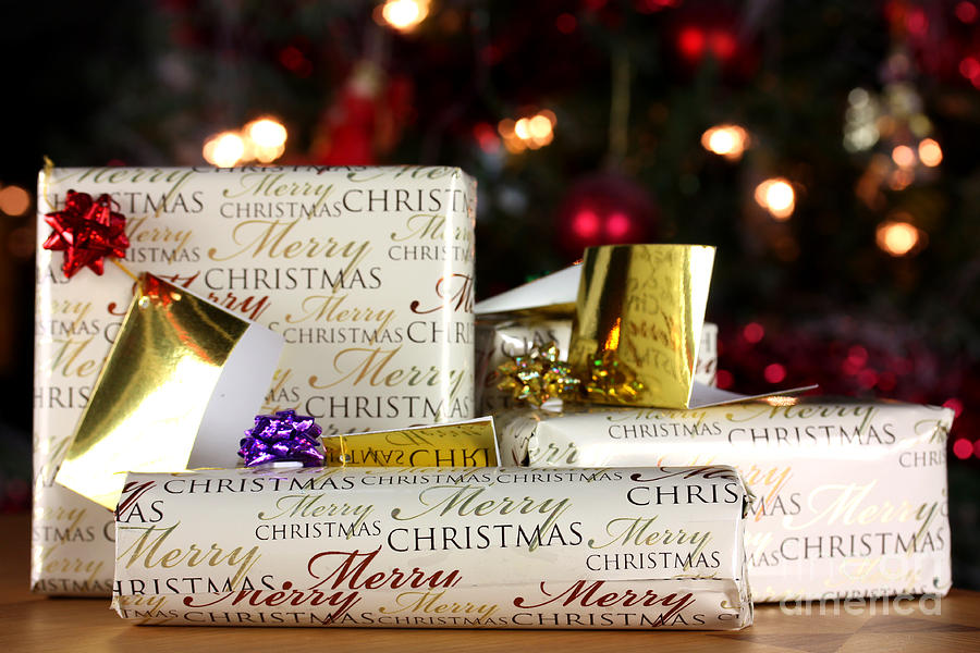 Christmas Photograph - Wrapped gifts with tags by Simon Bratt