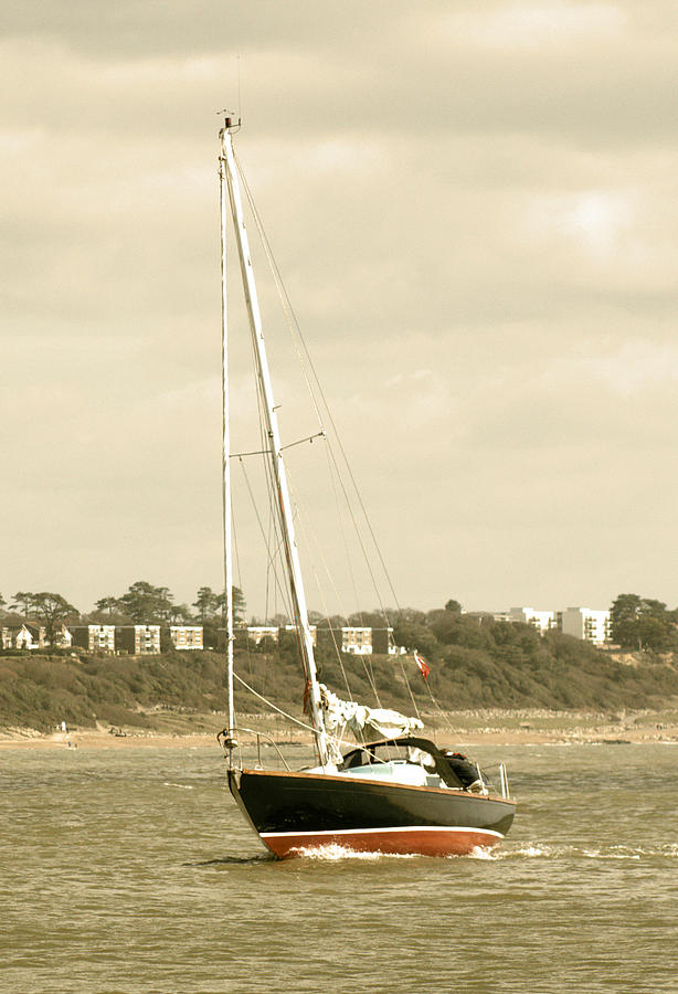 Yacht entering Christchurch harbour Photograph by Chris Day