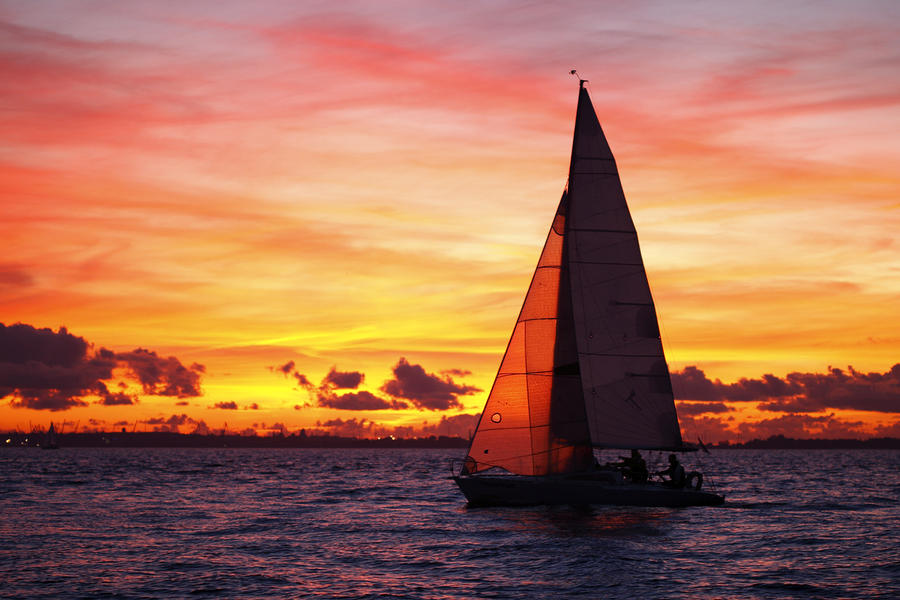 Yacht Sailing At Sunset by Romeo Koitmae