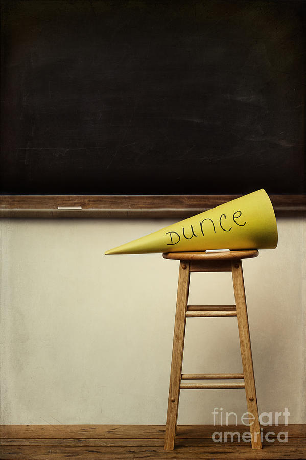 Yellow dunce hat on stool with chalkboard Photograph by Sandra Cunningham
