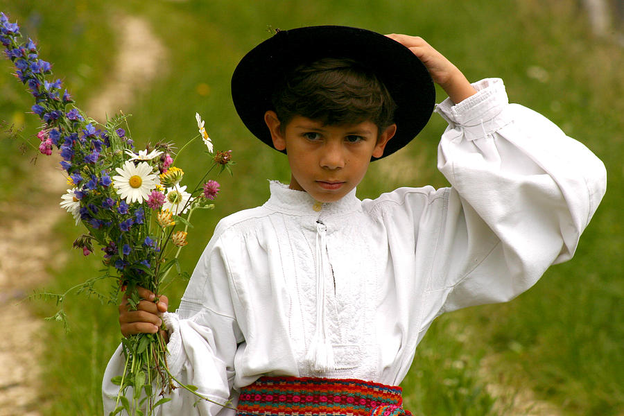 Young boy with wildflowers bouquet Photograph by Emanuel Tanjala