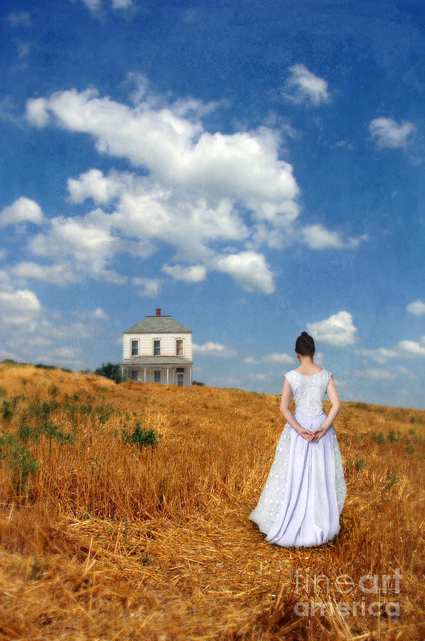 Young Lady In Wheat Field Looking At A Farmhouse