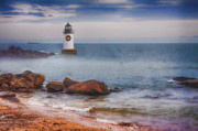 The fog rises at the lighthouse Photograph by Jeff Folger