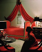 A Young Woman Sitting In A Red Bedroom Photograph by Horst P. Horst