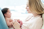 Baby Sitting On Mother's Lap Photograph by Science Photo Library