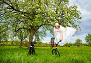 BMX Flatland Bride jumps in spring meadow Photograph by Matthias Hauser