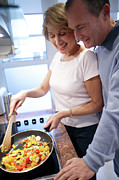 Couple Cooking Photograph by Science Photo Library