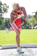 Fit Older Female Athlete Throws Shot Put Photograph by Science Photo Library