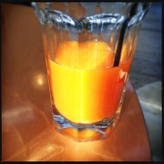 Glass with orange fruit juice Photograph by Matthias Hauser