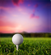 Golf ball on tee at sunset Photograph by Michal Bednarek