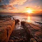 Long Exposure Sunset At A Rocky Reef In Photograph by Larry Marshall