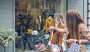 Two women looking at shop window of a boutique Photograph by Westend61