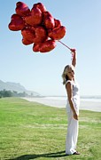 Woman Holding Heart-shaped Balloons Photograph by Science Photo Library