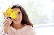 Woman Holding Leaf In Front Of Face Photograph by Science Photo Library